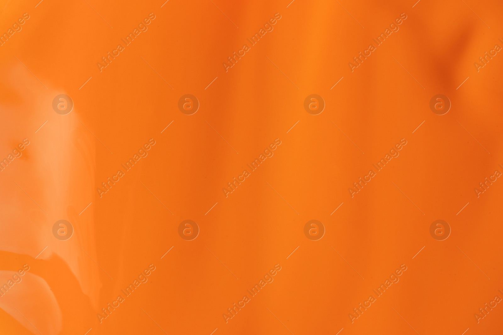 Photo of Bright orange paint as background, closeup view