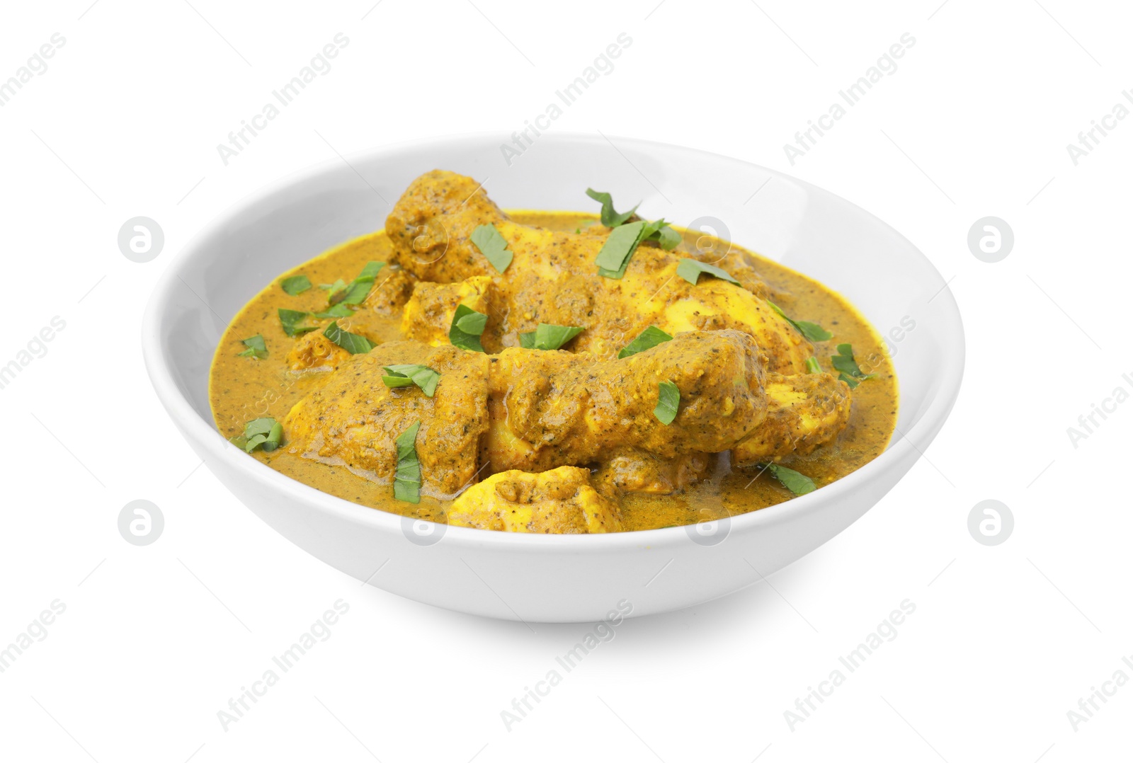 Photo of Delicious chicken with curry sauce and basil isolated on white