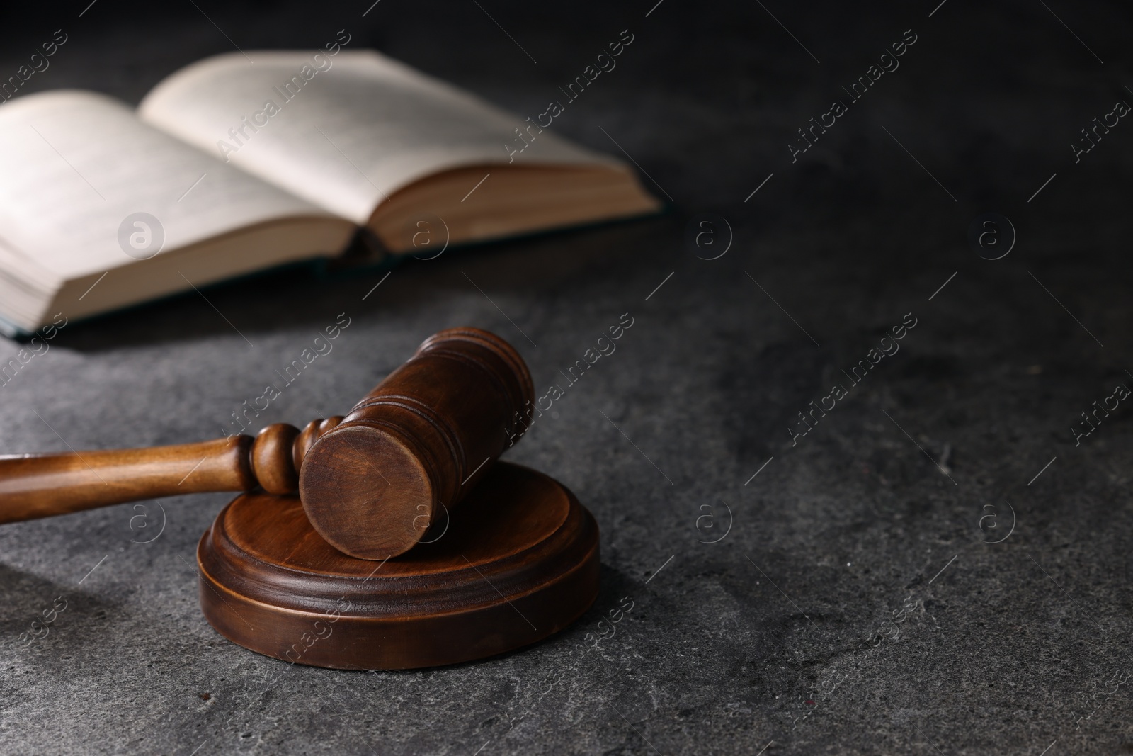 Photo of Law concept. Judge's gavel on grey textured table, space for text