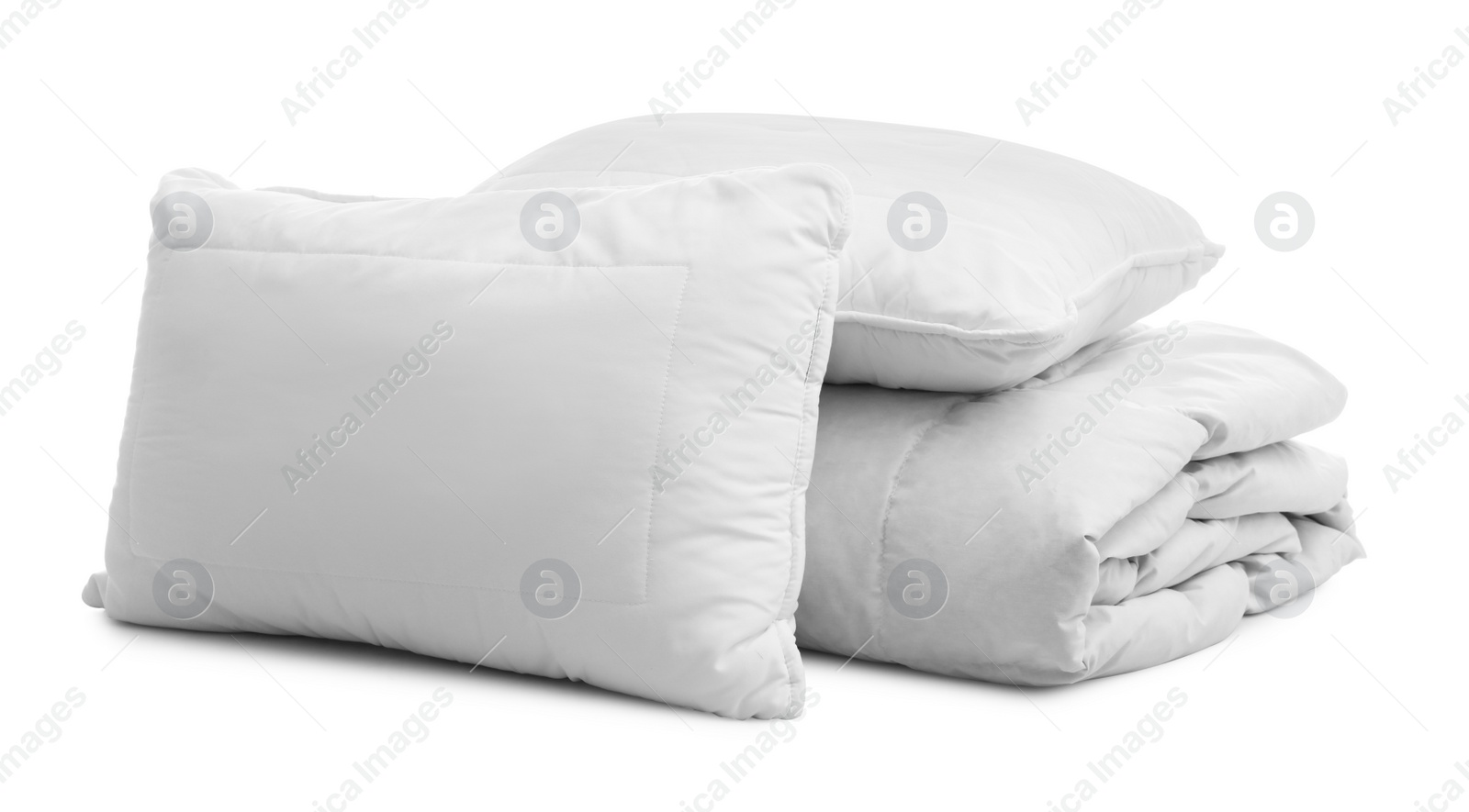 Photo of Soft blanket with pillows on white background