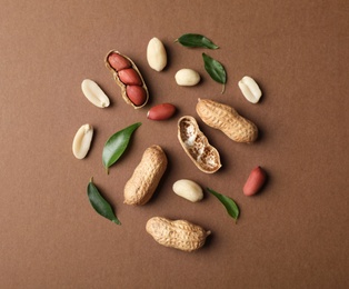 Photo of Composition with peanuts on color background, top view