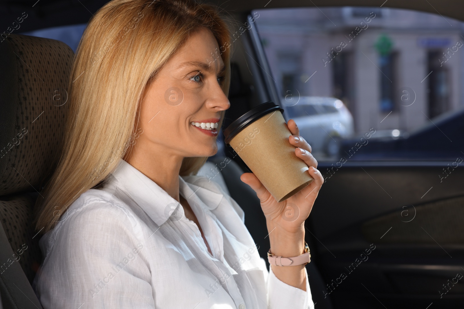 Photo of To-go drink. Woman drinking coffee in car, space for text