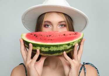 Photo of Beautiful girl with watermelon on grey background