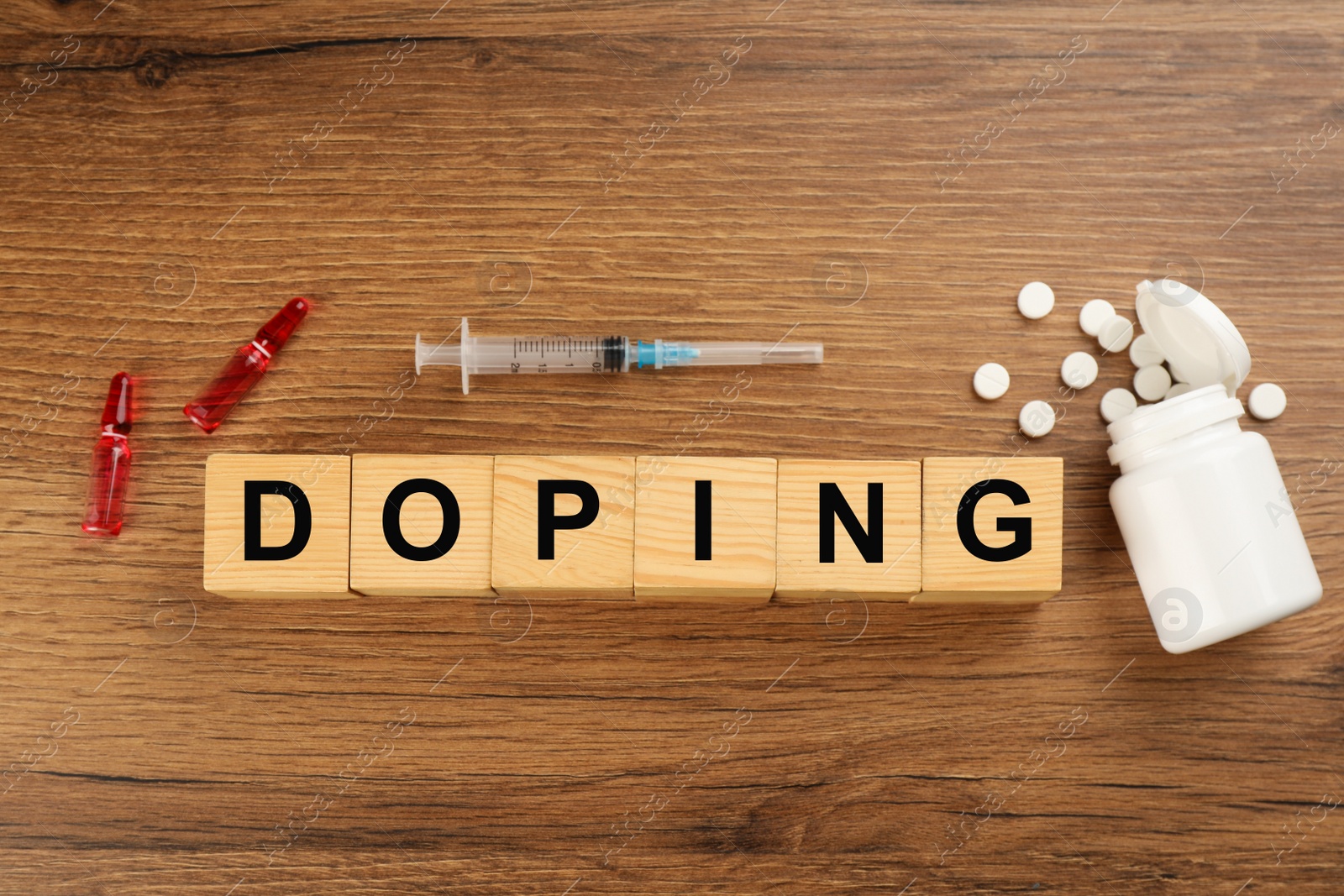 Photo of Cubes with word Doping and drugs on wooden background, flat lay