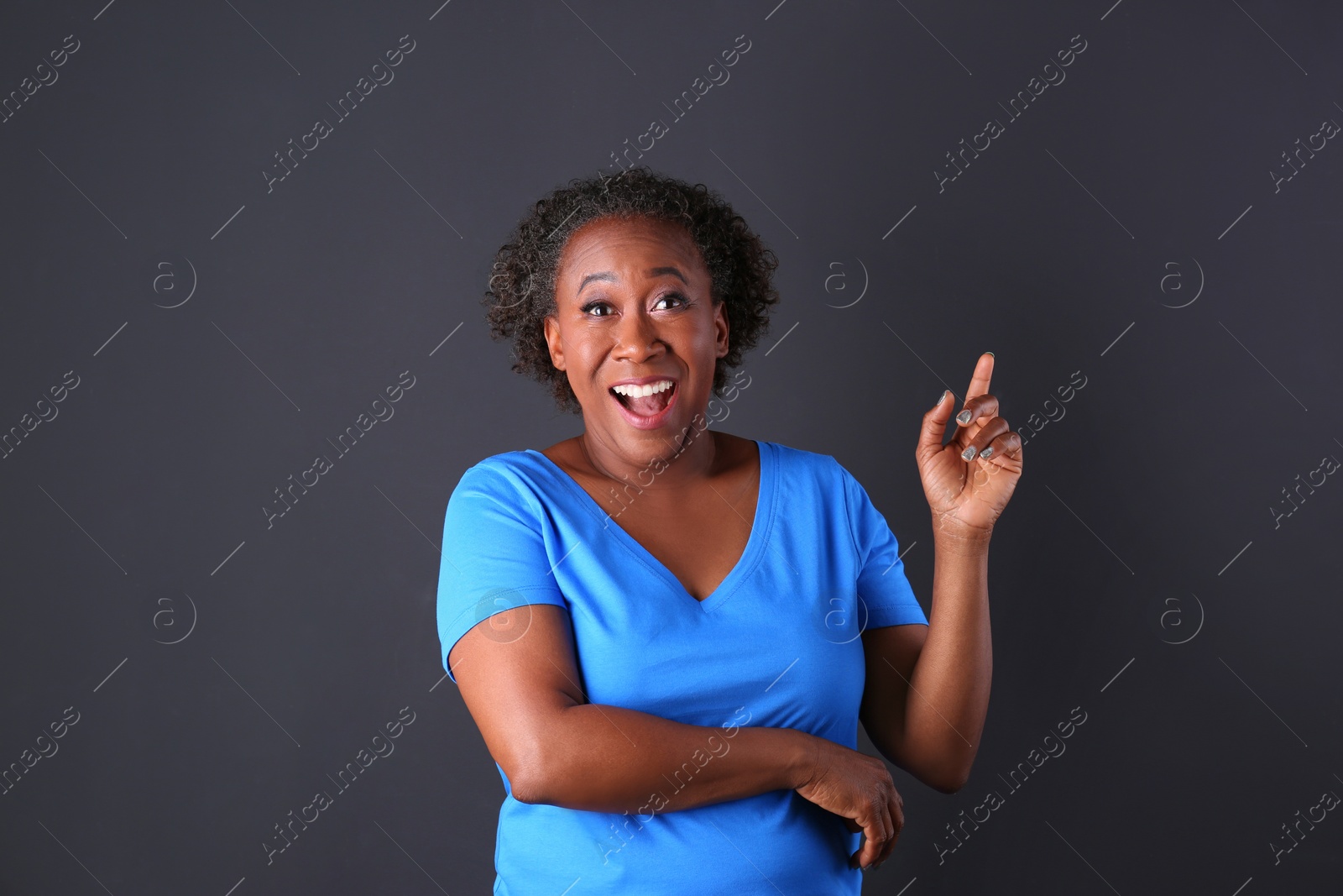 Photo of Portrait of happy African-American woman on black background