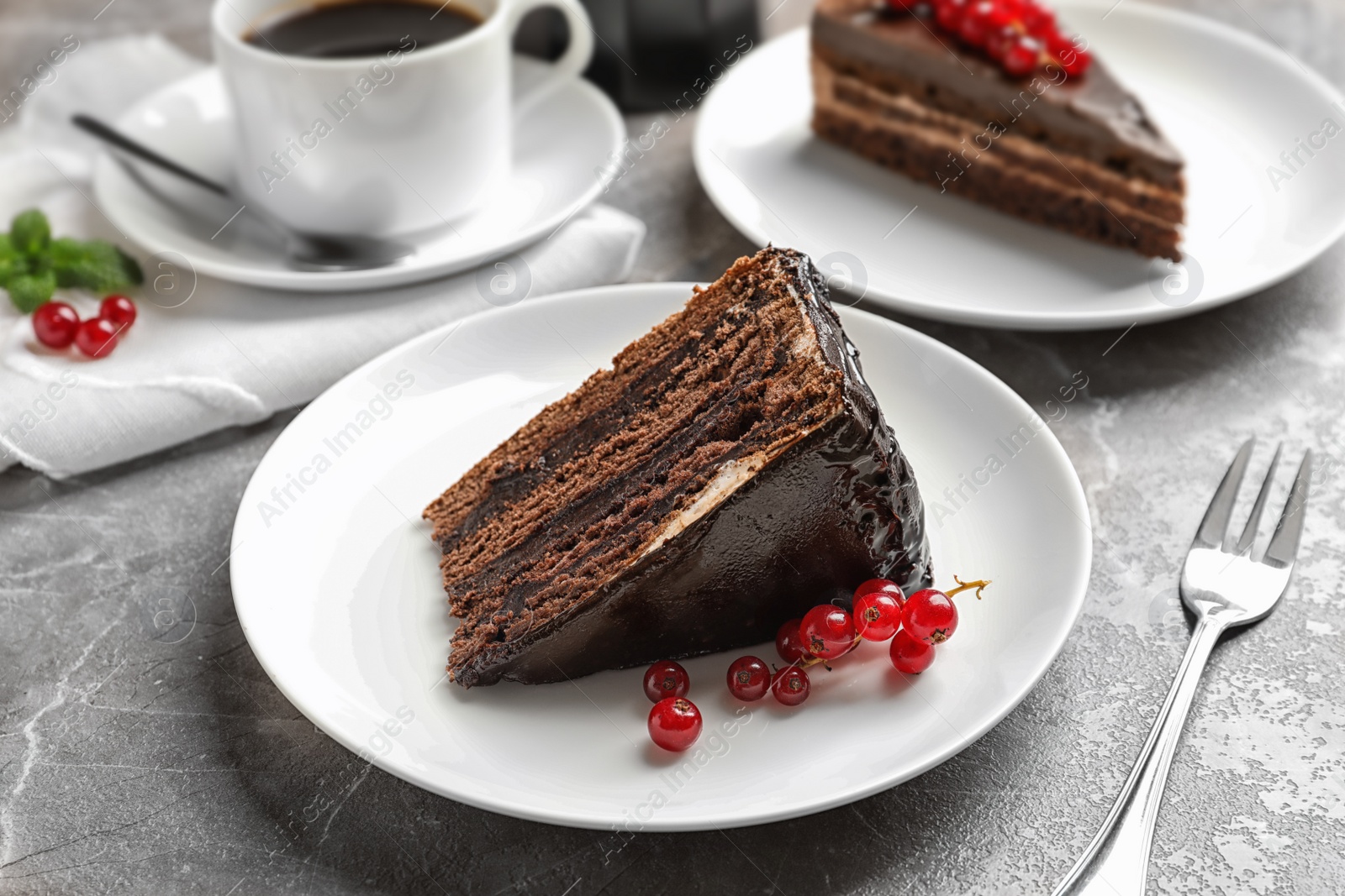 Photo of Slice of tasty chocolate cake with berries served on table