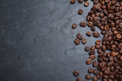 Photo of Many roasted coffee beans on black table, flat lay. Space for text