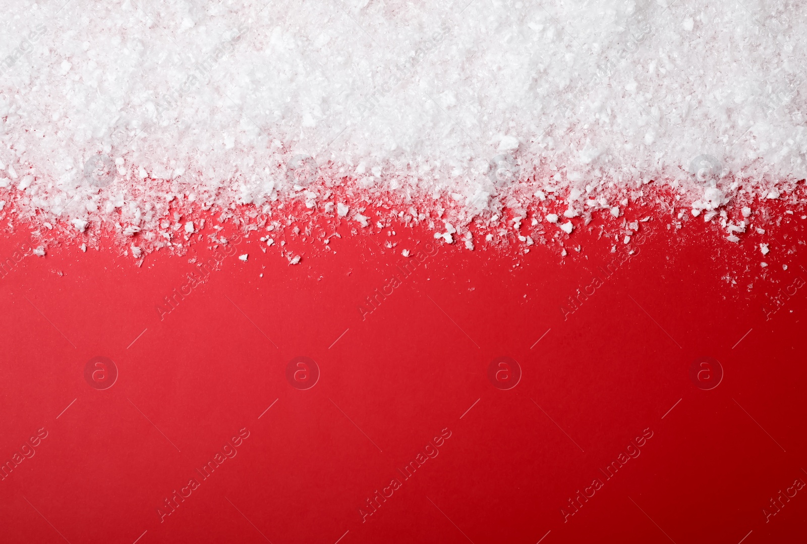 Photo of White snow and space for text on color background, top view