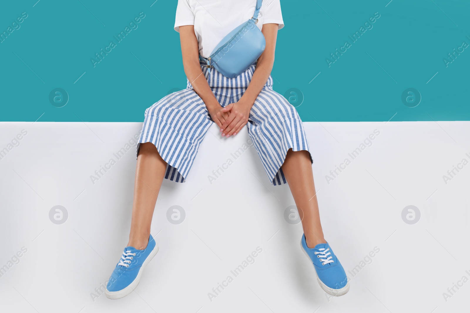 Photo of Woman wearing stylish shoes on color background, closeup