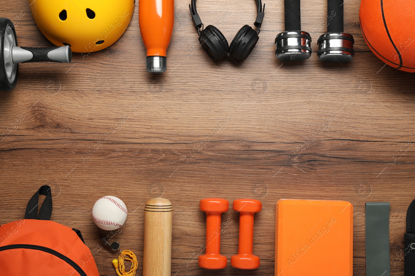 Photo of Frame made of different sports equipment on wooden table, flat lay. Space for text