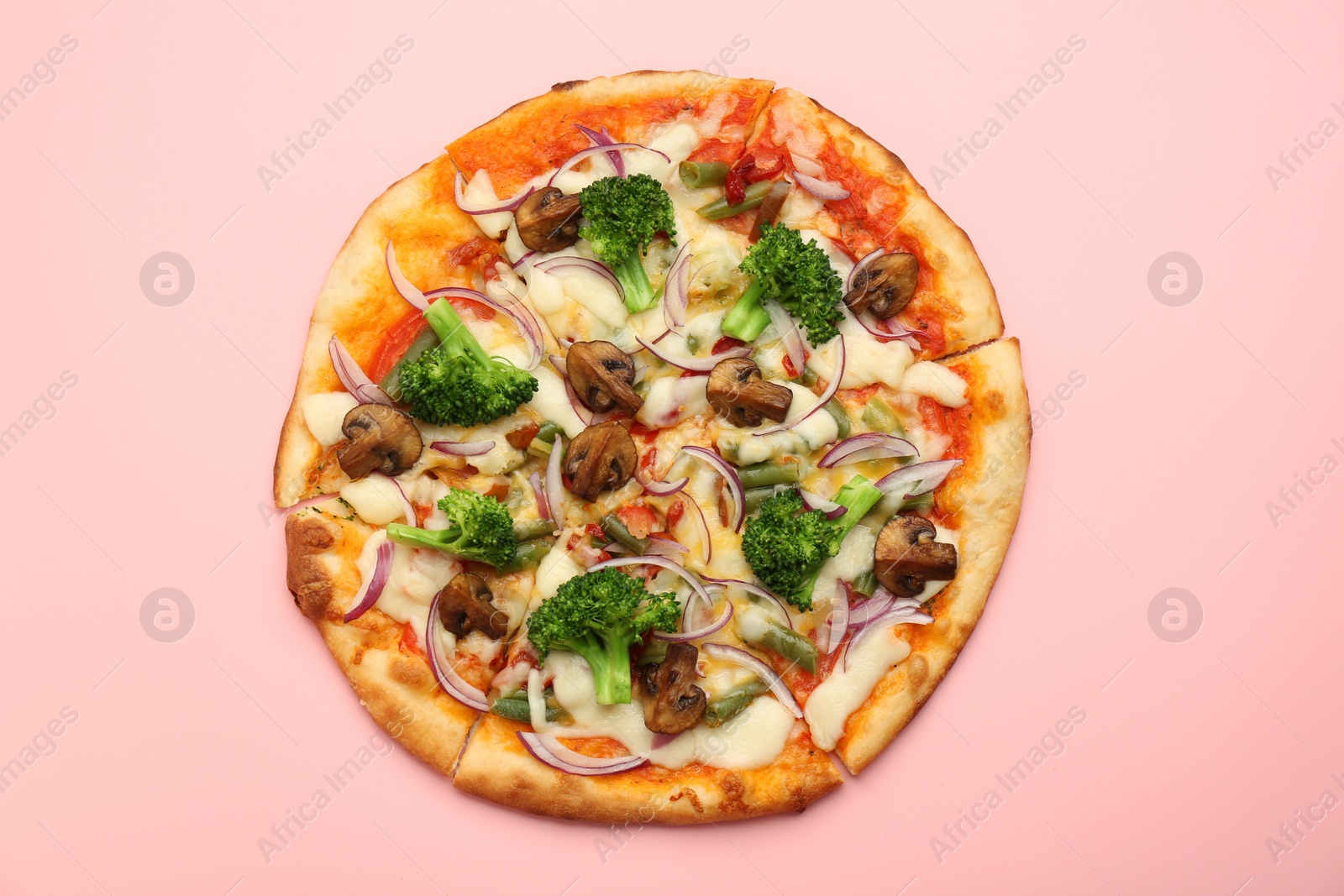 Photo of Delicious vegetarian pizza on pink table, top view