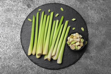 Fresh lemongrass stalks on grey table, top view