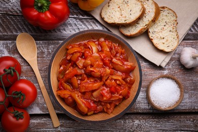 Photo of Delicious lecho and ingredients on wooden table, flat lay