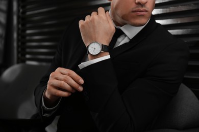 Photo of Businessman with luxury wrist watch indoors, closeup