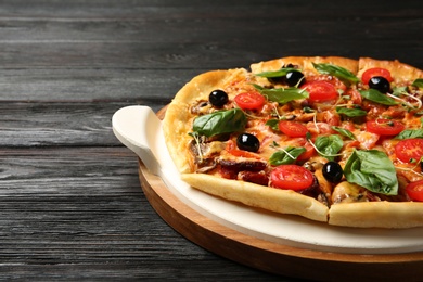 Photo of Tasty fresh homemade pizza on wooden table