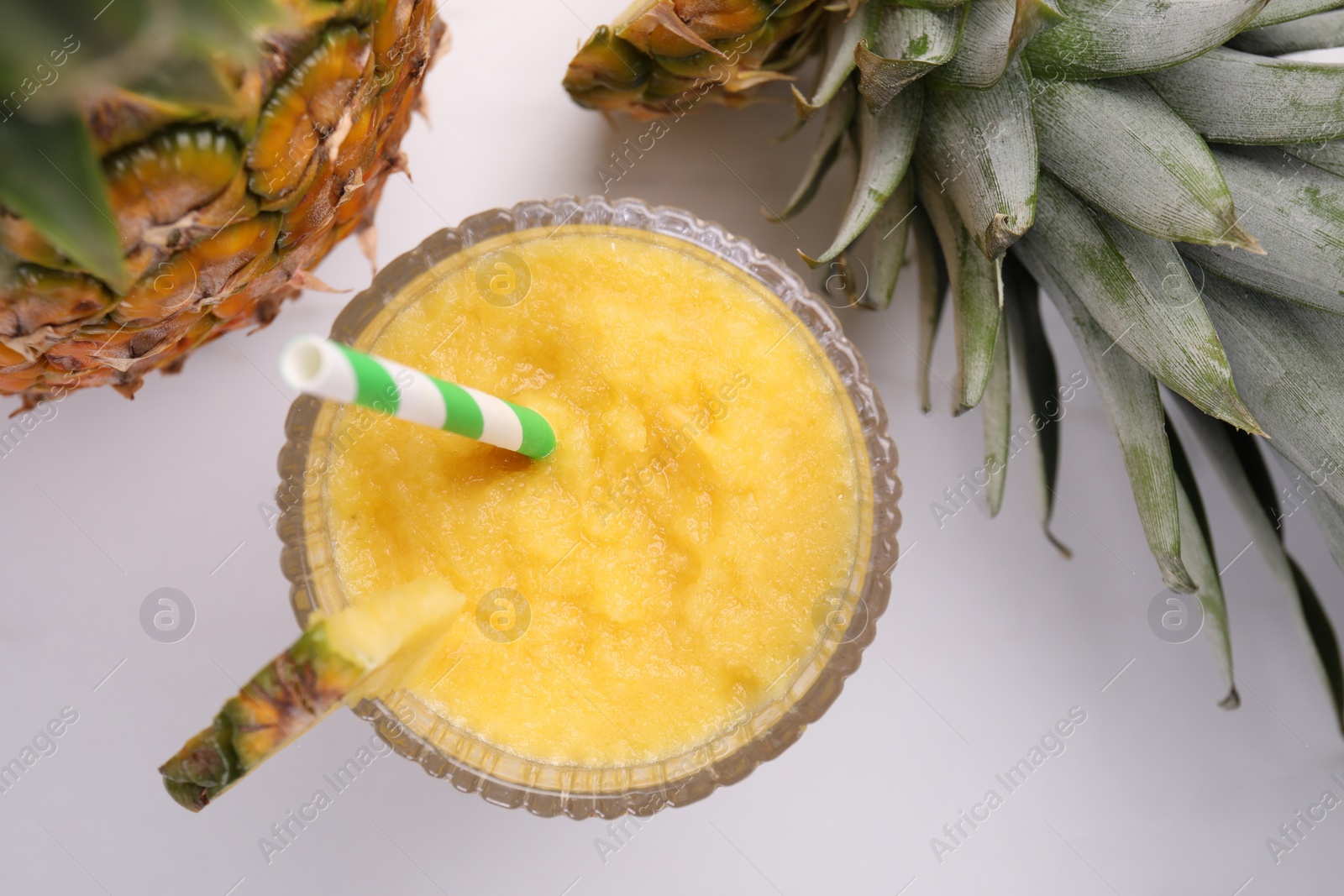 Photo of Tasty pineapple smoothie and fruits on white table, flat lay