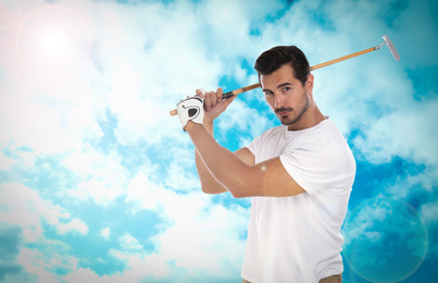 Image of Young man playing golf against blue sky