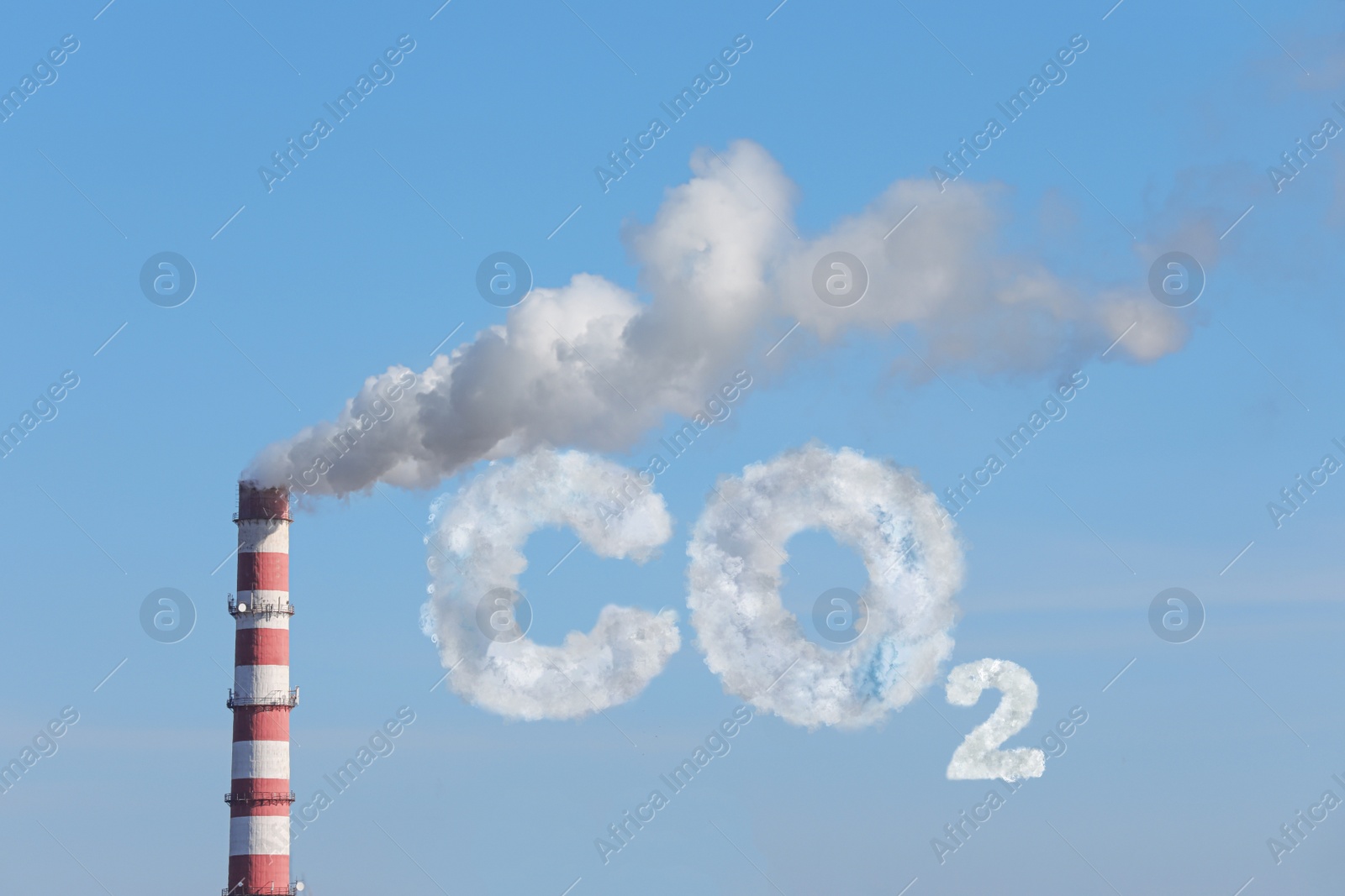 Image of  Inscription CO2 made of smoke. Polluting air from industrial chimney outdoors against blue sky 