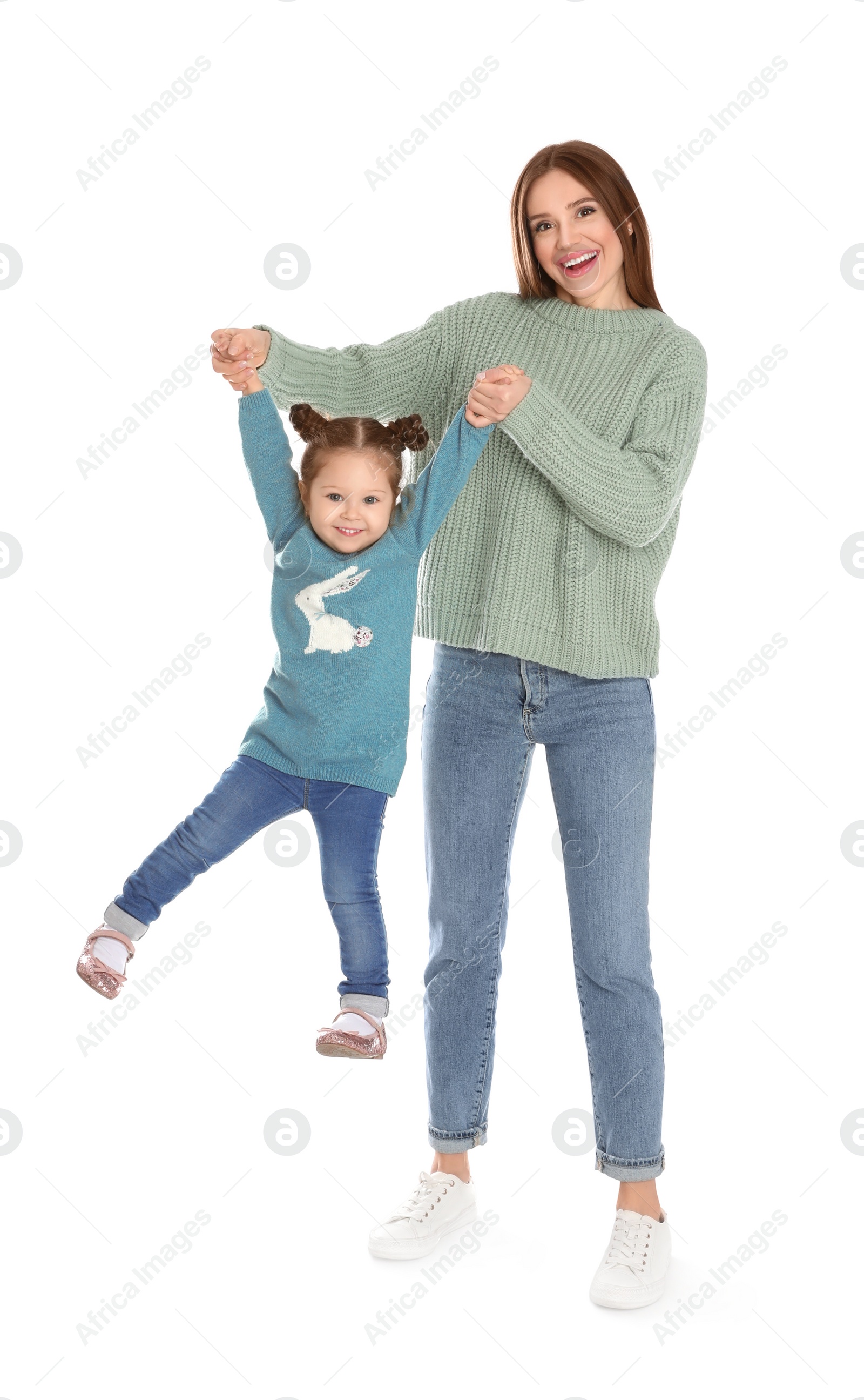 Photo of Young mother with little daughter having fun on white background