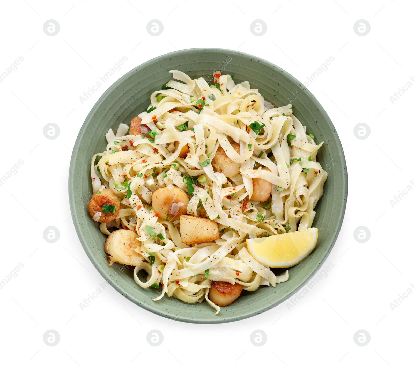 Photo of Delicious scallop pasta with spices and lemon in bowl isolated on white, top view
