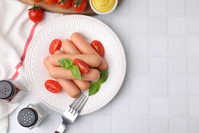 Photo of Delicious boiled sausages with tomatoes and basil served on white tiled table, flat lay. Space for text