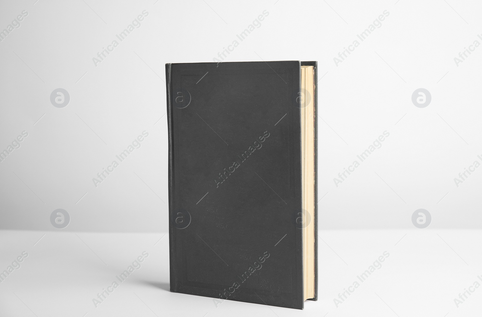 Photo of Hardcover book on white background. Space for design