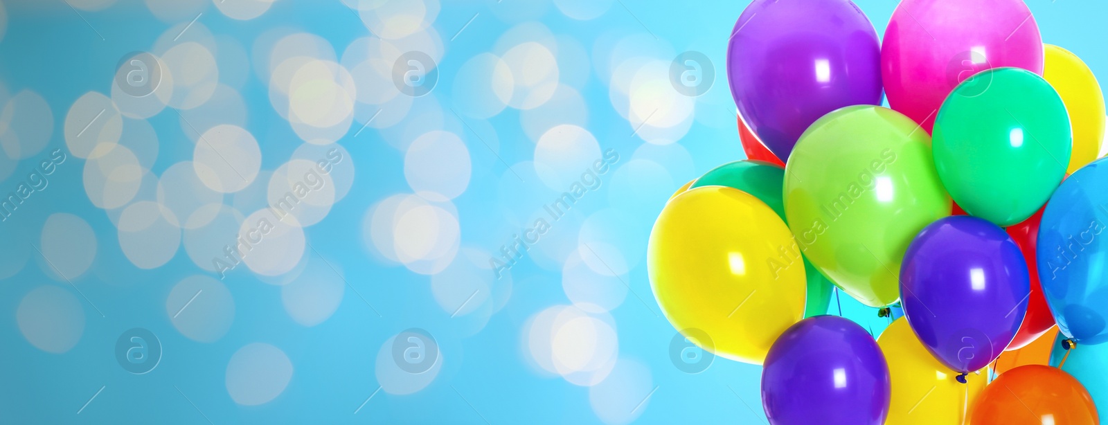 Image of Bright balloons on color background with bokeh effect, space for text. Banner design