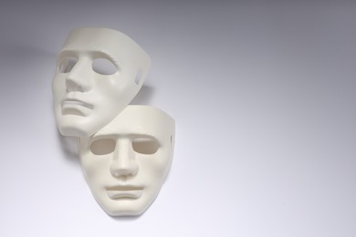 Theater arts. Two masks on white background, above view. Space for text