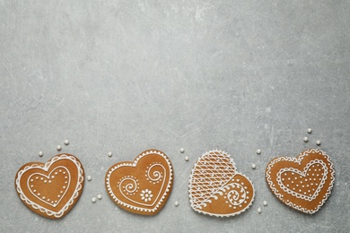 Tasty heart shaped gingerbread cookies on grey table, flat lay. Space for text