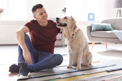 Portrait of owner with his friendly dog at home