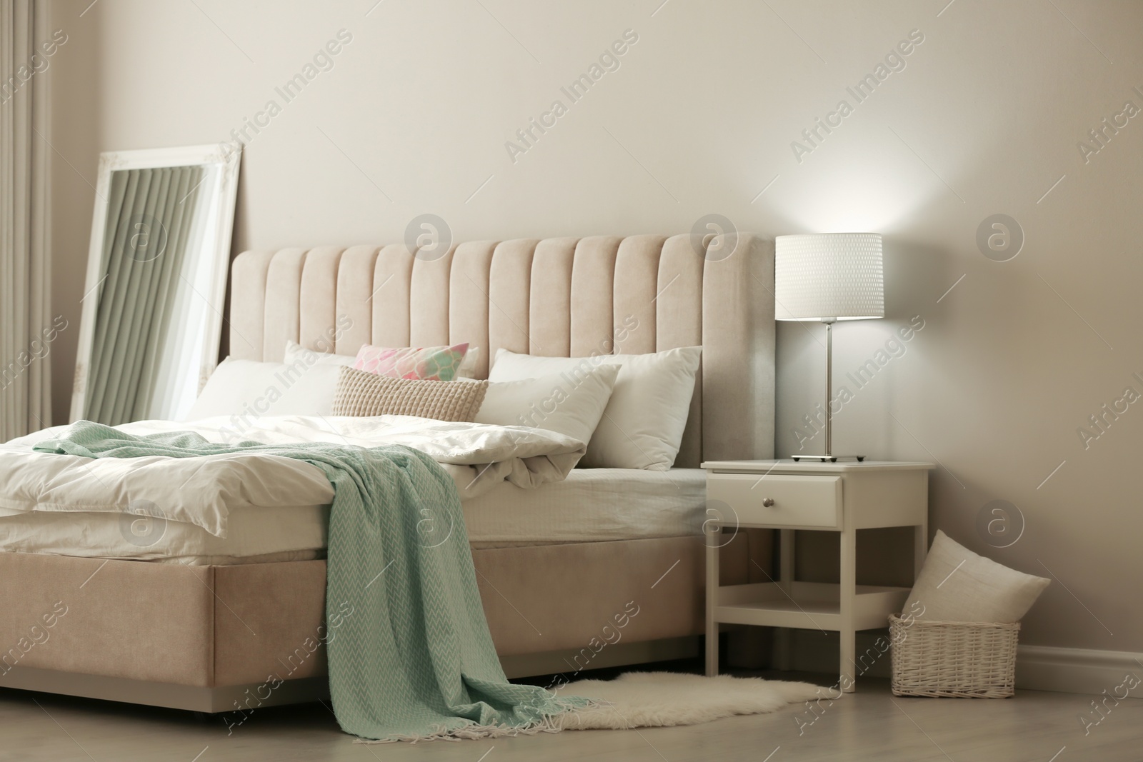 Photo of Stylish room interior with large comfortable bed 