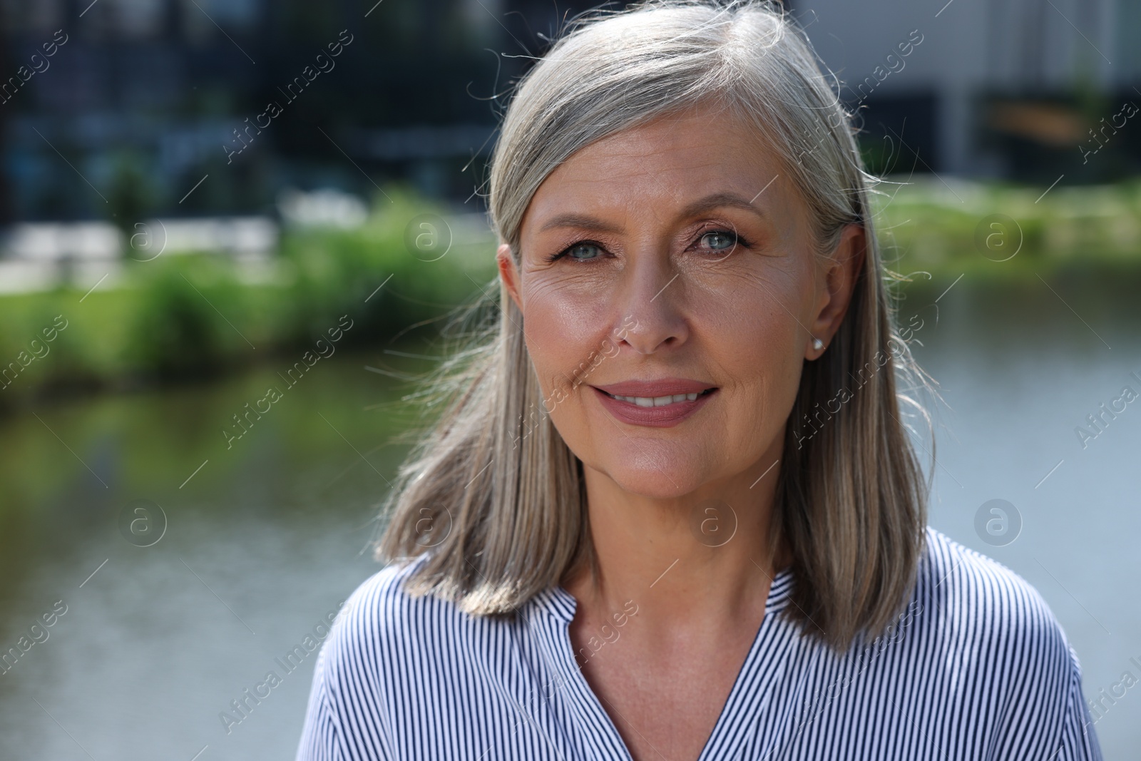 Photo of Portrait of beautiful happy senior woman outdoors