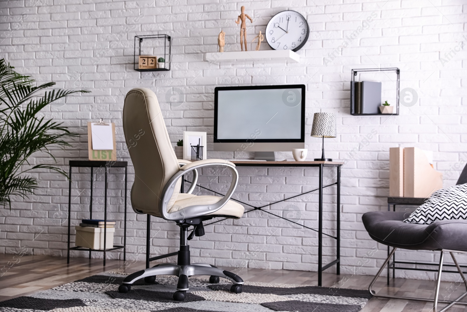 Photo of Comfortable chair near desk in modern office interior