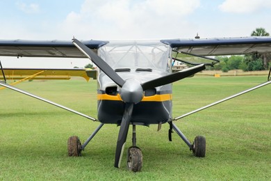 View of beautiful ultralight airplane in field on autumn day