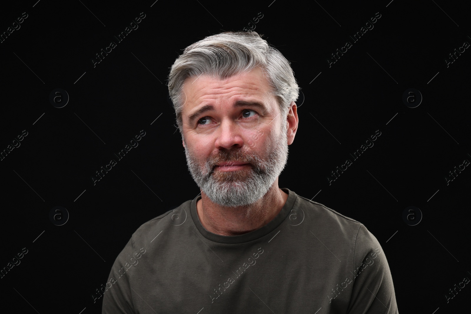 Photo of Personality concept. Portrait of emotional man on black background