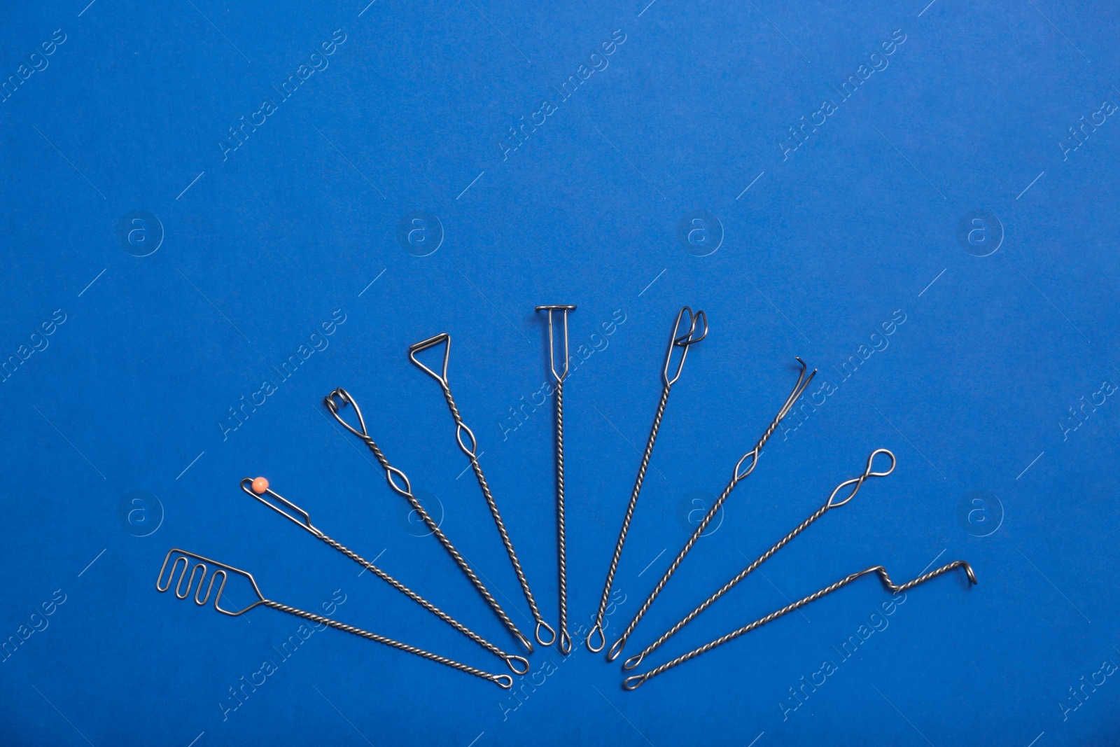 Photo of Set of logopedic probes for speech therapy on blue background, flat lay. Space for text