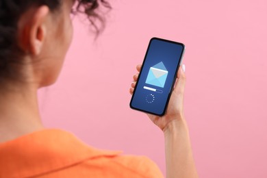 Image of Got new message. Woman holding smartphone on pink background, closeup