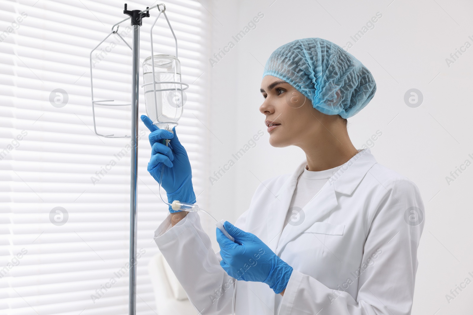 Photo of Nurse setting up IV drip in hospital