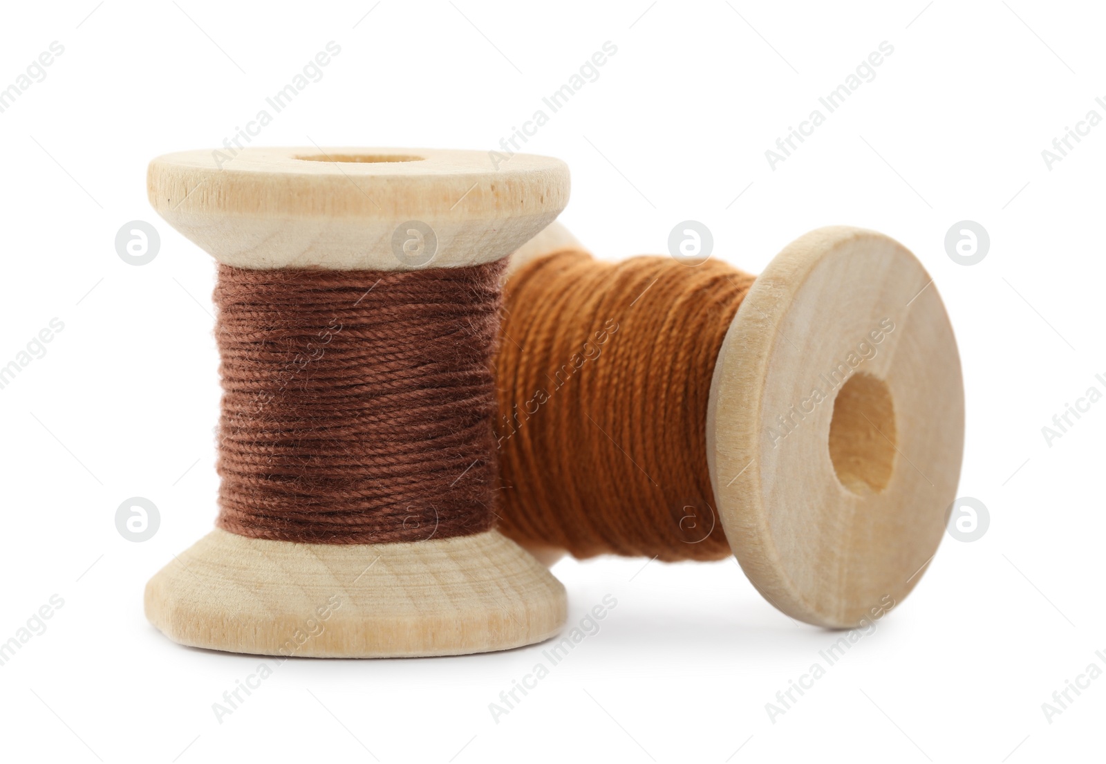 Photo of Different colorful sewing threads on white background