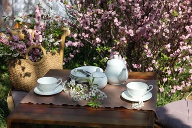 Beautiful spring flowers on table served for tea drinking in garden