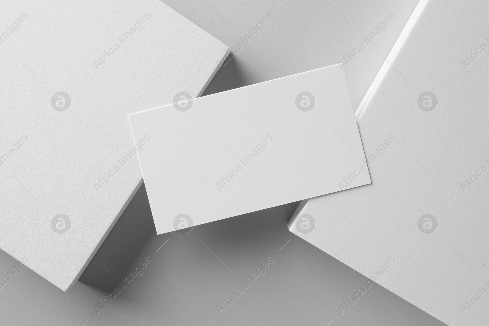 Photo of Empty business card and decorative elements on white background, top view. Mockup for design