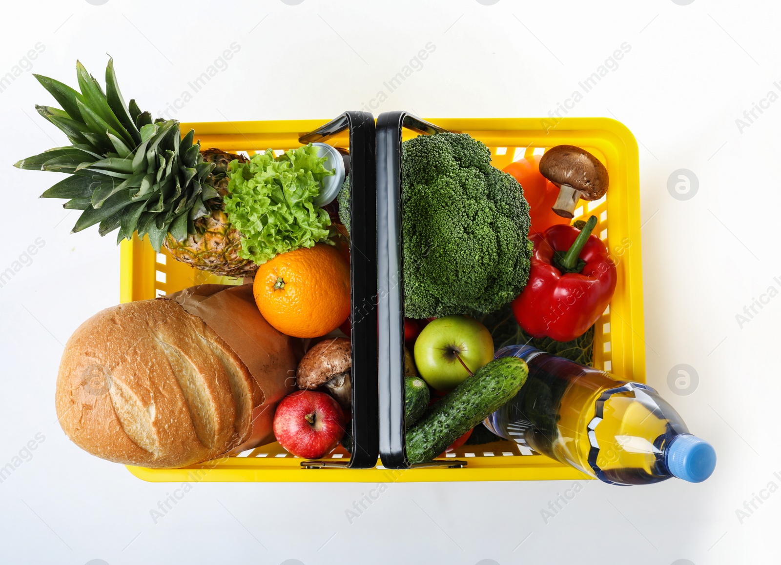 Photo of Shopping basket with grocery products on white background, top view