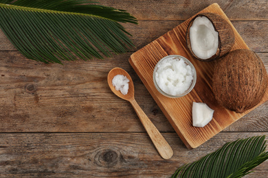 Flat lay composition with coconut oil on wooden table. Cooking ingredients