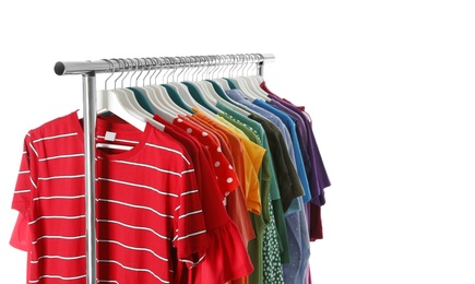 Wardrobe rack with different colorful clothes on white background