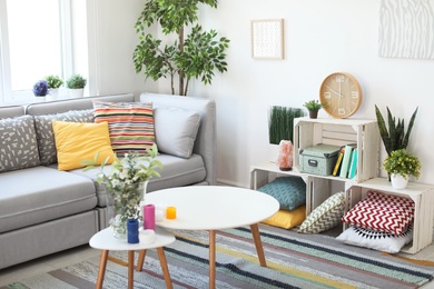 Photo of Interior of modern living room with pillows on sofa