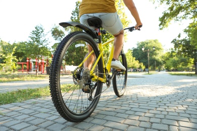 Photo of Young man with bicycle in city park, closeup