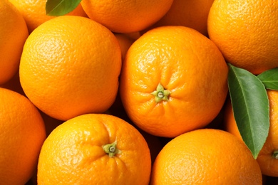 Photo of Pile of ripe oranges as background, top view