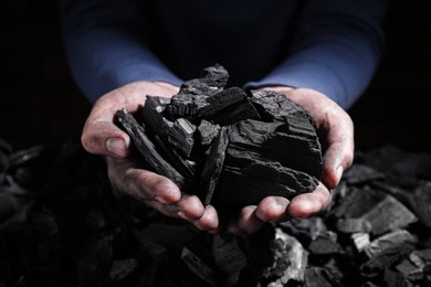 Photo of Man with handful of coal, closeup view