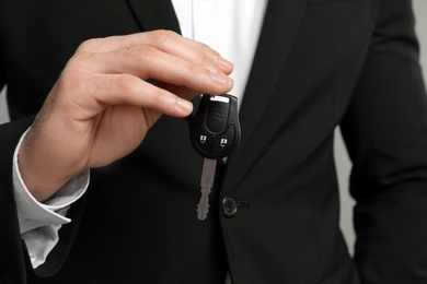 Young man holding new car key, closeup