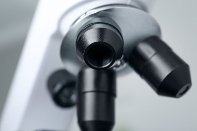 Photo of Closeup view of modern medical microscope on grey background